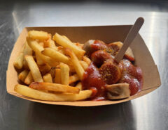 Authentic bite-size German Thüringer Style Bratwurst served with fries, covered with warm C273 curry sauce.